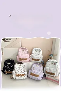 Close-up of cute cartoon bear backpacks in pink, white, purple and black color options