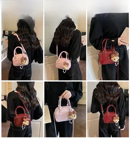 Detail shots of mini Boston bag in pink and burgundy featuring cute bear charms