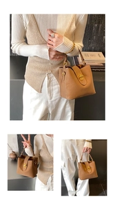 Close-up of a minimalist light brown bucket bag with premium gold metal buckle detail