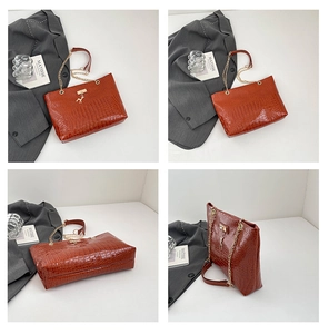 Detail of reddish-brown croc-effect tote bag with gold chain strap and deer charm detail