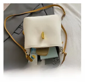 Internal view of beige leather bucket bag showing storage space for phone and wallet