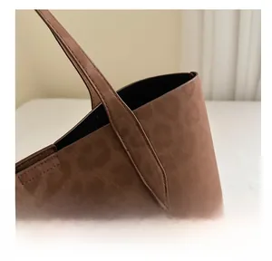 Detail of high-quality stitching and handle attachment on brown leopard print tote bag