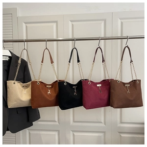 Five suede tote bags in various colors with metallic deer pendant and chain straps