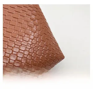 Close-up of brown woven leather texture with high-quality cross-weave craftsmanship
