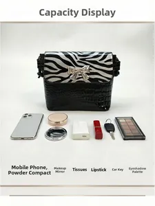 Detail view of mini zebra print crossbody bag showing its interior storage capacity