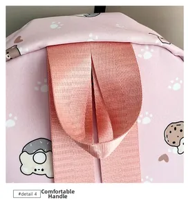 Detail of pink canvas backpack showing a comfortable woven handle and cute cartoon patterns