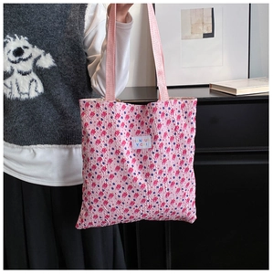 Detail of pink bubble textured tote bag featuring purple dots and TIANYU YCAI label
