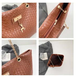 Detailed view of woven leather tote bag featuring gold hardware and chain shoulder strap
