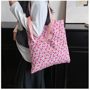 Detail of pink bubble fabric tote bag with floral patterns and woven shoulder strap