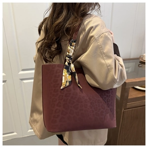 Detail of burgundy leopard print tote bag with a decorative vintage floral silk scarf