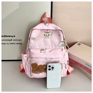 Detail view of pink cartoon bear backpack with front zipper pocket and size reference