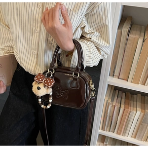 Deep brown faux leather mini bag featuring horse embossing and a cute bear charm