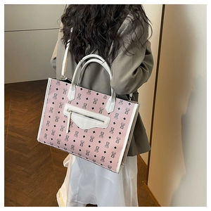 Model showing pink cartoon bear tote bag with white leather straps and large capacity
