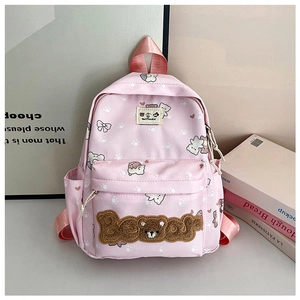 Close-up of pink canvas backpack with cute cartoon bear prints and plush Bear embroidery