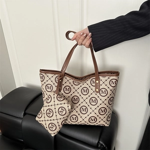 Classic monogram canvas tote bag with leather handles and matching small zip pouch set