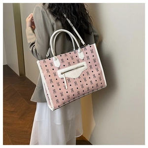 Detail of pink bear tote bag with lychee texture being worn by a model in soft lighting