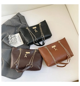 Three woven tote bags in black and brown featuring gold deer charms and chain straps