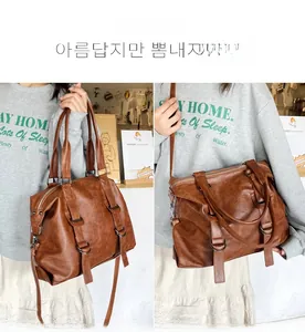 Detailed view of brown retro tote bag featuring buckle straps and adjustable shoulder strap