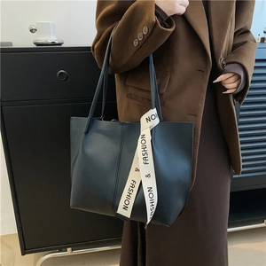 Chic large capacity tote bag with fashion ribbon detail and sleek PU leather finish