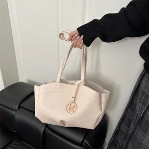Chic beige large capacity tote bag with wave cut edge and gold M letter pendant charm