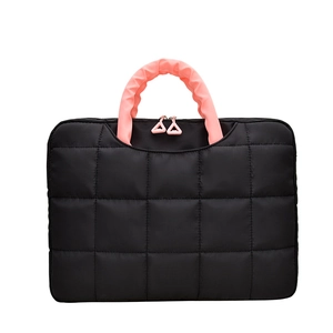 Quilted black briefcase laptop bag with contrasting pink ruched handles and zippers