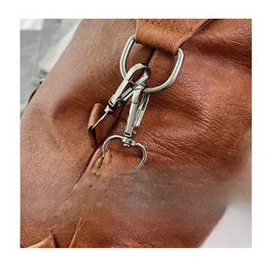Close-up of gunmetal hardware D-ring and hook on dark brown pebble leather bag