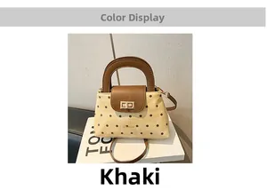 Detailed close-up of khaki polka dot tote bag with brown leather flap and golden twist lock