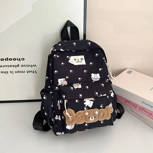 Cute black backpack with white paw prints and a 3D plush bear mascot on the front pocket