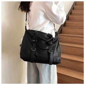 Modern black PU leather tote bag shown on model for a realistic size and style perspective