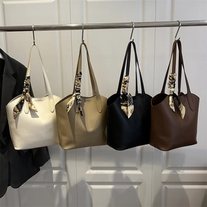 Minimalist bucket tote bags in four colors featuring decorative silk scarves on handles