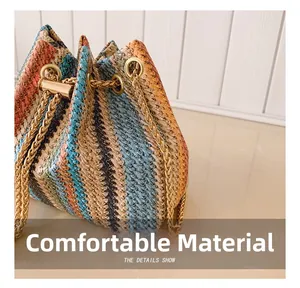 Close-up of bohemian striped woven bucket bag with gold chain drawstring and hardware