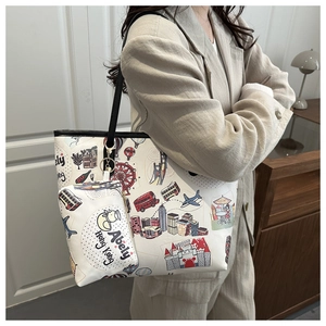 Detail of printed tote bag with cartoon city patterns shown on shoulder of a model