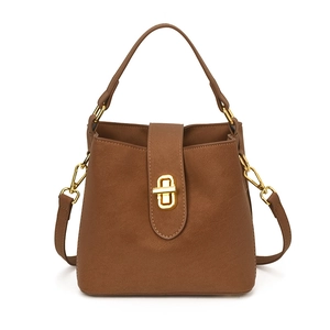 Caramel brown leather bucket bag with top handle and gold clasp for women