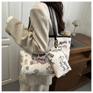 Detail view of large white tote bag with cartoon Hong Kong print and matching pouch