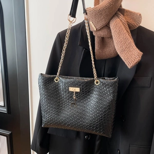 Classic black woven leather tote bag with gold chain strap and deer pendant