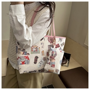 Detail of printed graffiti tote bag set with pink handles and city illustrations