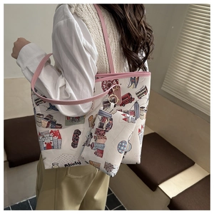 Detail of bear tote bag showing colorful London cartoon prints and pink shoulder straps