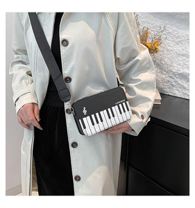 Detail view of piano keyboard bag with I LOVE MUSIC print and treble clef icon