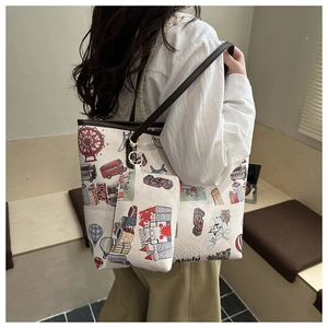 Detail of floral doodle tote bag set with matching coin purse and brown leather straps