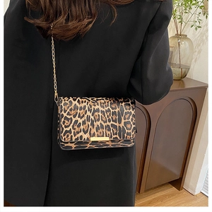 Detail of leopard print small square bag featuring golden chain and metal buckle