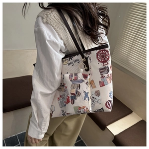 Detail of large tote bag with city illustration print and matching small zip pouch