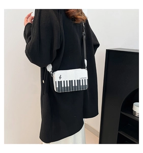 Detail of cross-body music bag with piano keys and I LOVE MUSIC text print