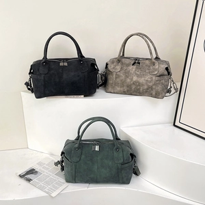 Retro matte leather tote bags in black, taupe, and green on a minimalist white stand