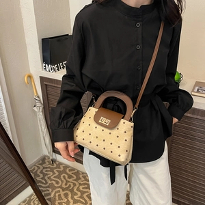 Retro polka dot handbag with brown handles and crossbody strap for daily casual wear