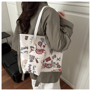 Detail view of large white tote bag and coin purse with Hong Kong city illustrations