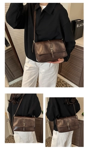 Detail view of a vintage dark brown leather crossbody bag with a sleek metal buckle closure