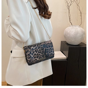 Chic leopard print shoulder bag with gold chain strap shown on model for outfit style
