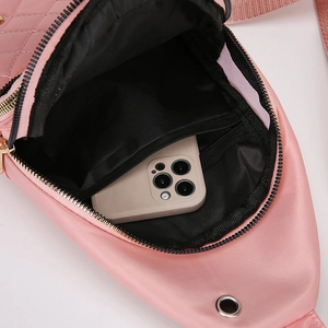 Pink quilted crossbody bag interior view showing storage space for a smartphone