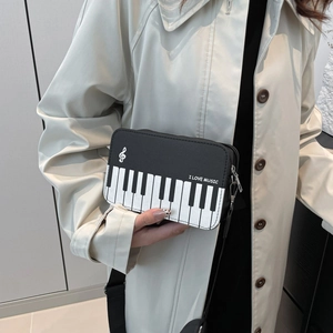 Chic piano key crossbody bag with I Love Music print and adjustable strap on a model