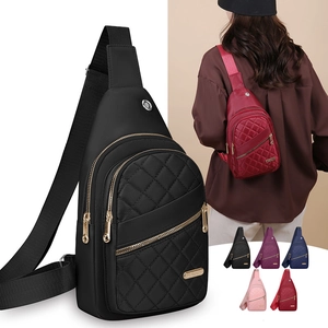 Detail view of quilted nylon chest bag with adjustable strap and multiple zipper pockets